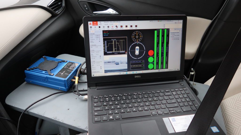 Laptop in a car testing a new installed device